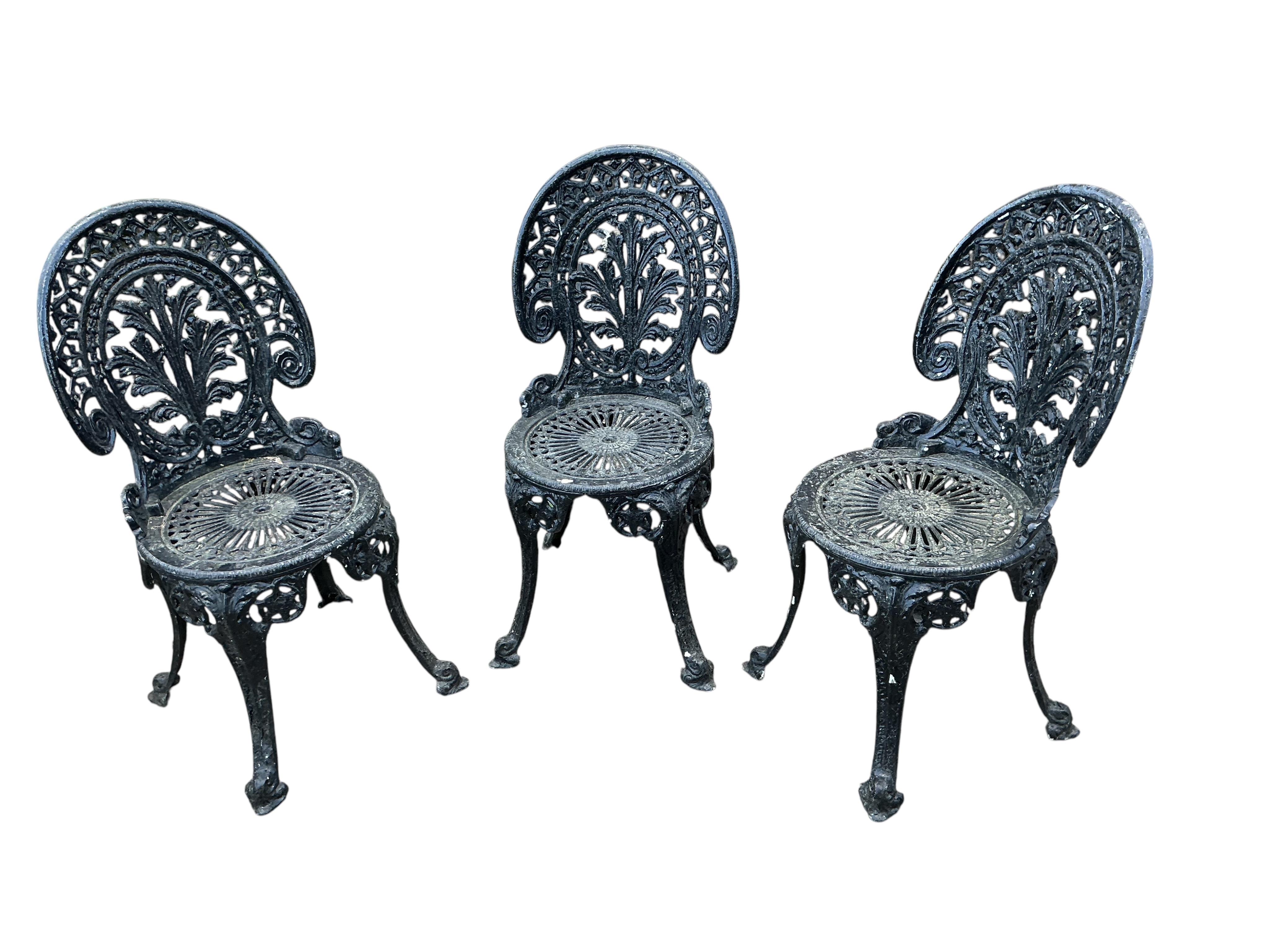 A Victorian style painted aluminium garden table, diameter 66cm and three chairs